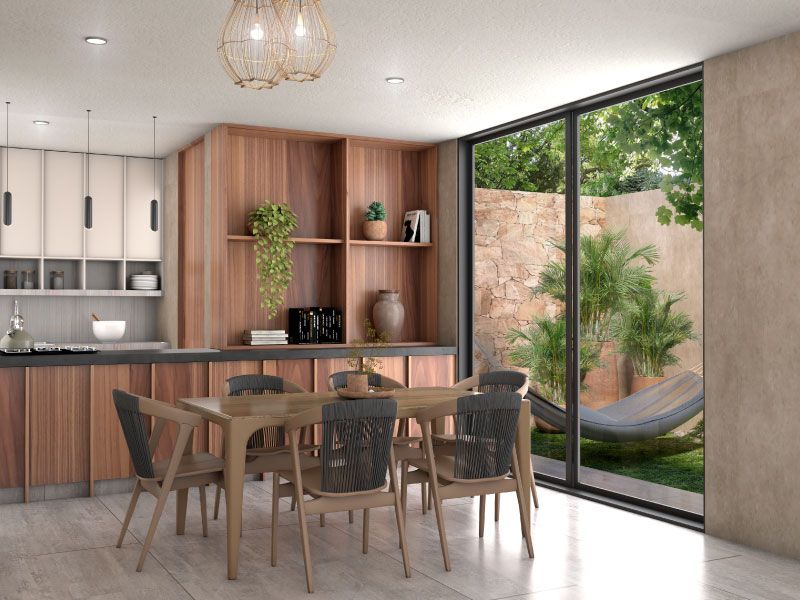 Cocina con alacenas de madera y comedor junto al ventanal, con hamaca en el patio