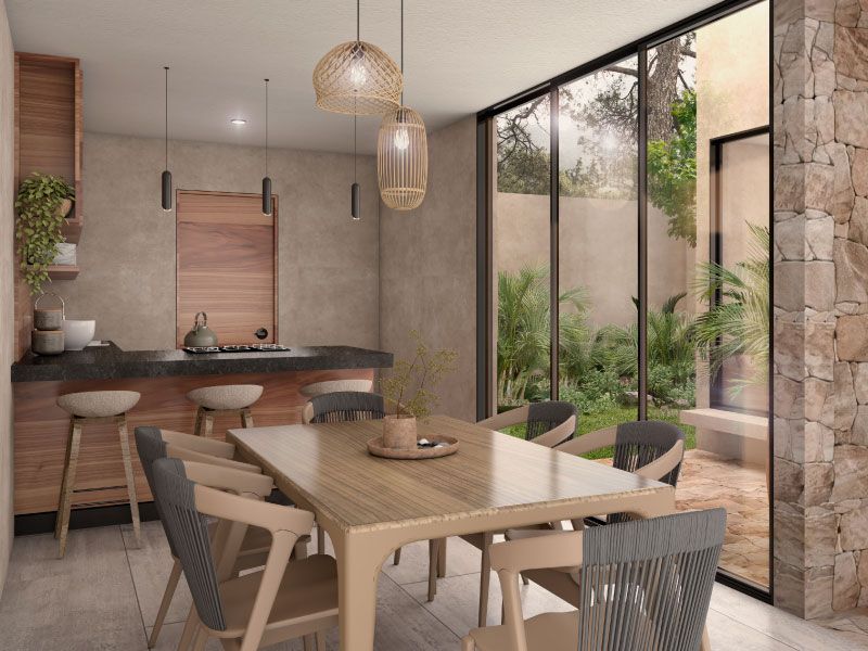 Cocina con barra y desayunador, mesa de madera y ventanales de piso a techo hacia el patio